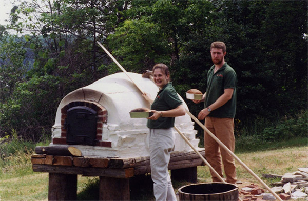 Staff baking bread with the bread oven in 1999. They baked bread once a week and gave it to museum visitors