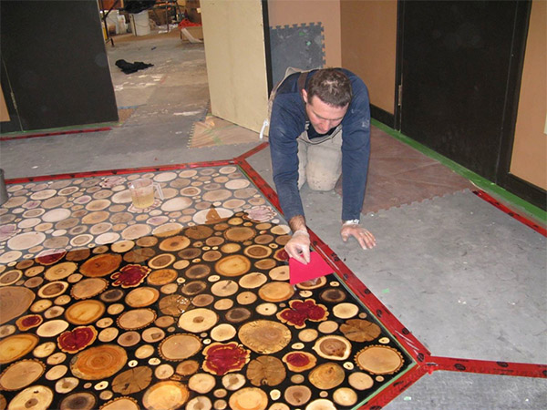 Premature degradation of the original wood floor required its replacement in 2009 using a different technique to achieve a similar effect